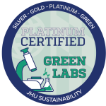 Johns Hopkins Office of Sustainability Green Lab badge for platinum certification. It is a circular blue and green logo with a lab microscope.