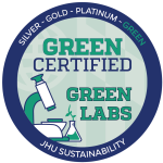 Johns Hopkins Office of Sustainability Green Lab badge for platinum certification. It is a circular blue and green logo with a lab microscope.