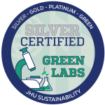 Johns Hopkins Office of Sustainability Green Lab badge for Silver certification. It is a circular blue and green logo with a lab microscope.