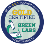 Johns Hopkins Office of Sustainability Green Lab badge for gold certification. It is a circular blue and green logo with a lab microscope.