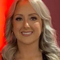 Headshot of Tiffany Debro with a red background