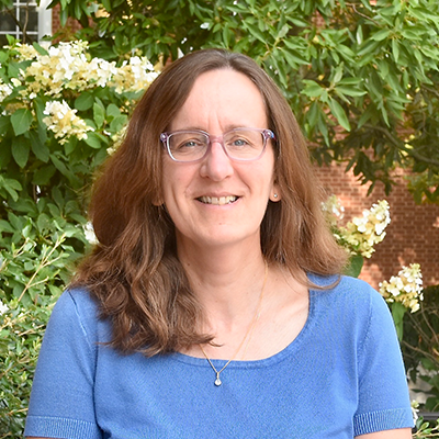 Headshot of Laurence Polewczak with trees in the background