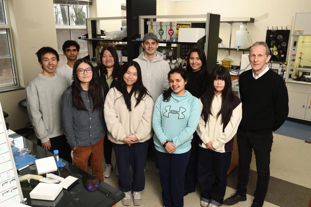 Peter Searson and his lab standing in their lab located in Croft Hall